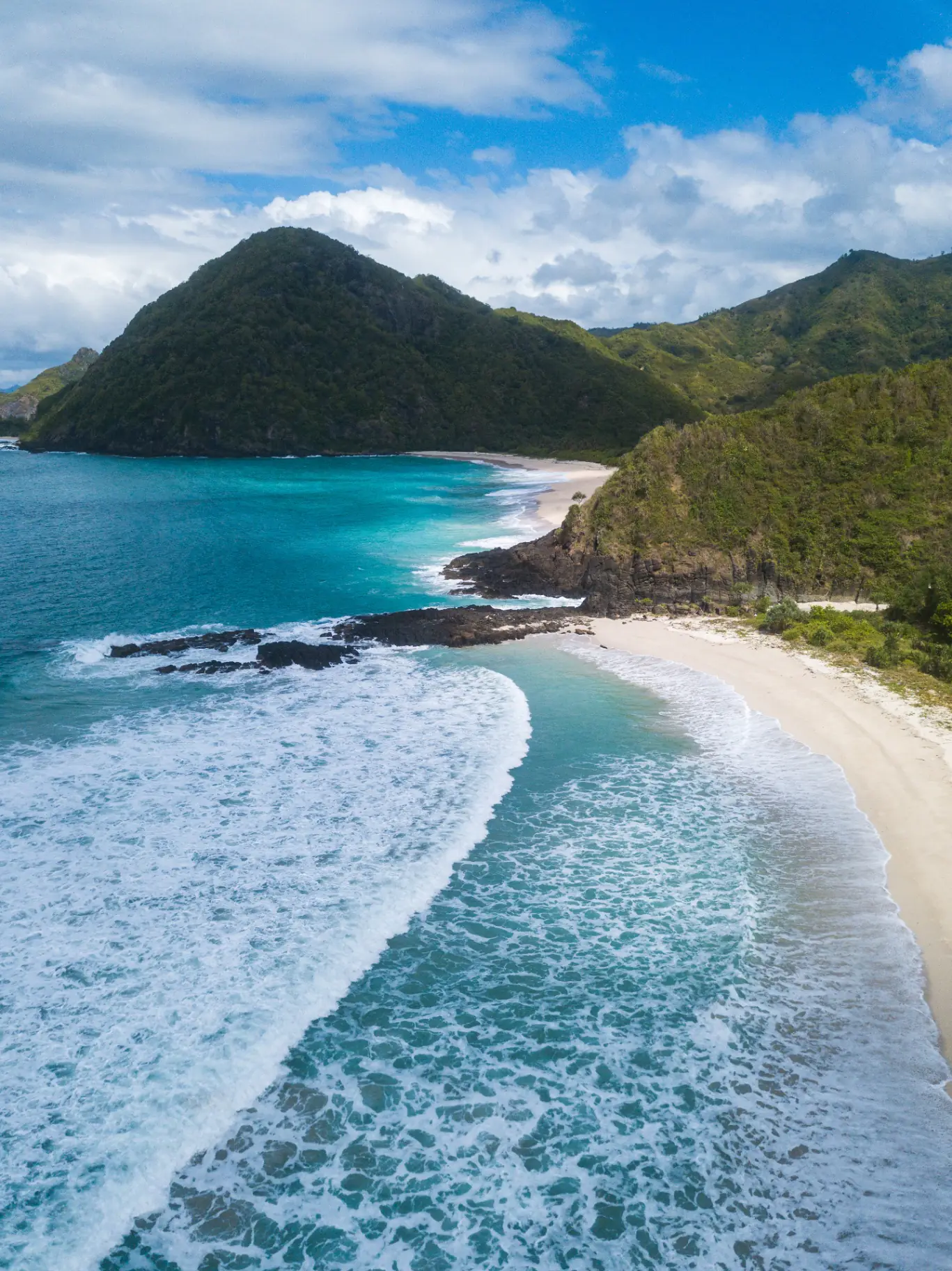 Aerial view across Selong Belanak bay, beach and surrounding hills